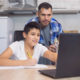 Father and son working together on a laptop at home