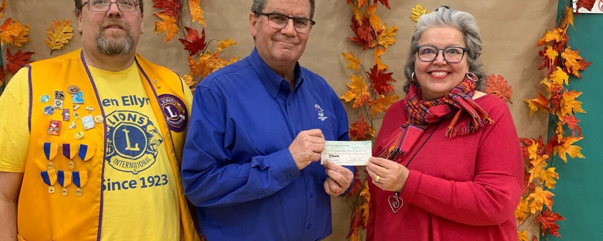 GECRC board president accepting a check from the Glen Ellyn Lions Club